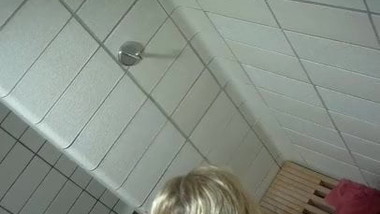 Blonde girl taking a shower