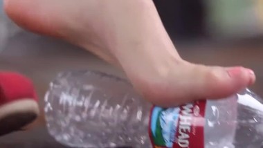 Beautiful girl Foot crush bottle with dirty feet